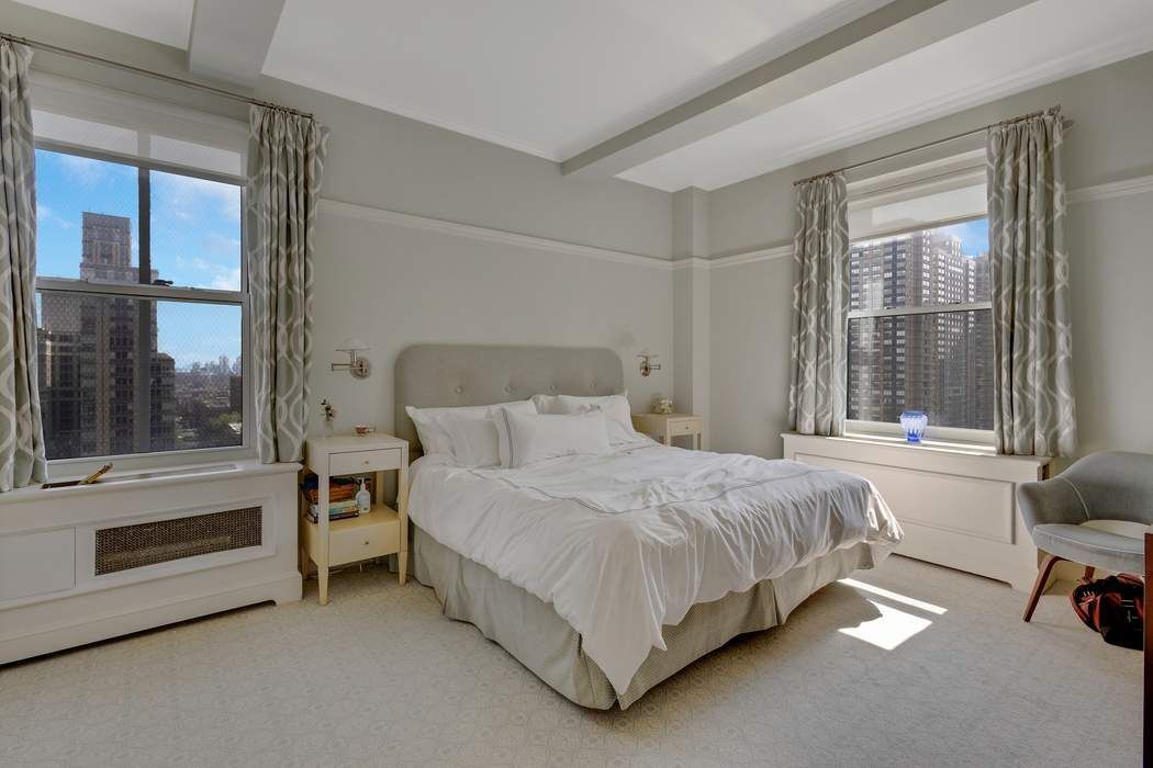 139 East 94th Street, Unit 11CD Manhattan, NY 10128 - Photo 15 of 28 a bedroom with a bed and a view of living room