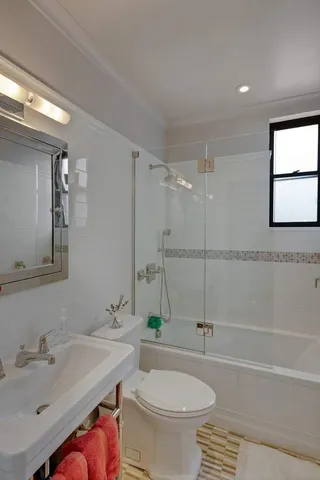 a bedroom with double bed and a dresser