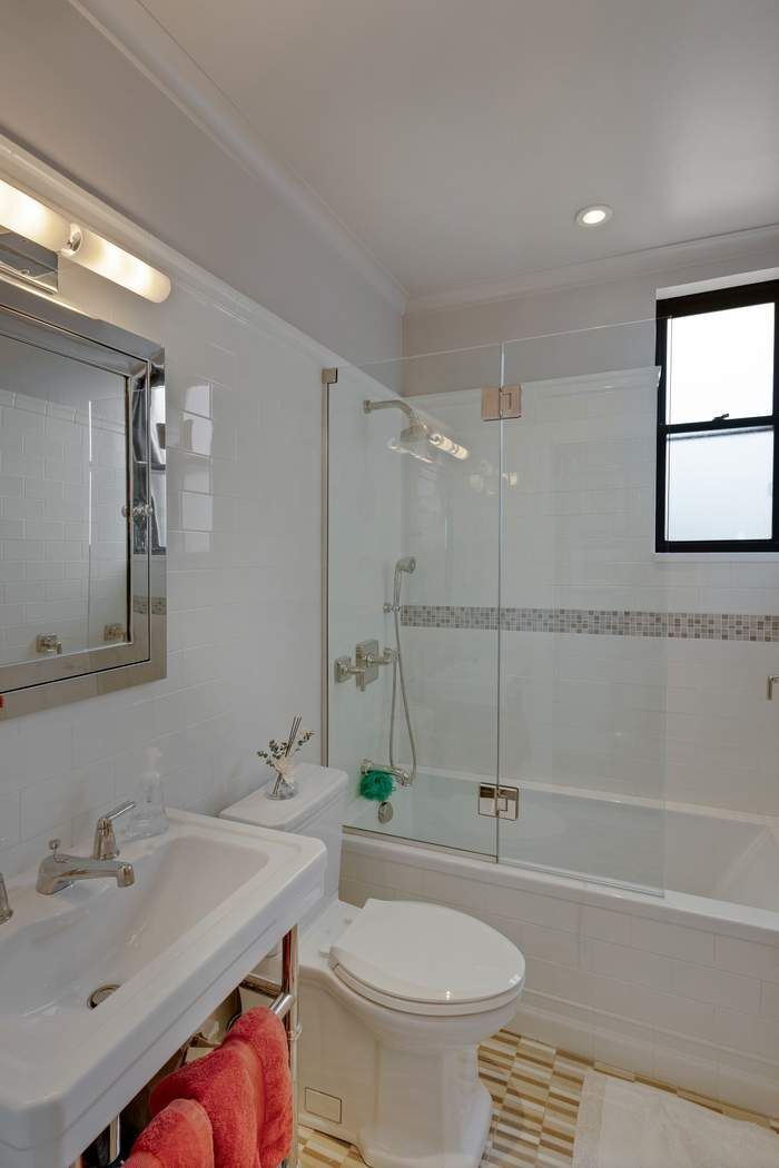 139 East 94th Street, Unit 11CD Manhattan, NY 10128 - Photo 18 of 28 a bathroom with a sink a toilet and shower