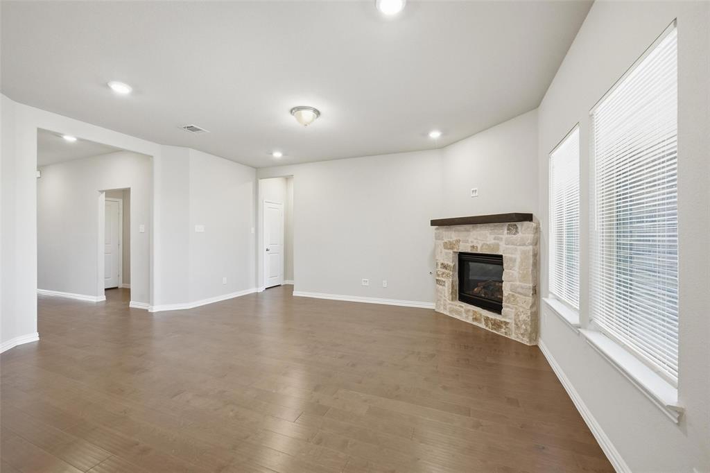 1116 Rountree Court Celina, TX 75009 - Photo 14 of 29 an empty room with windows and fireplace