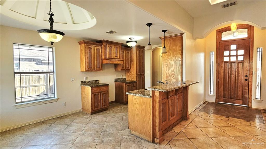 1004 West F Street Mission, TX 78572 - Photo 2 of 12 a kitchen with stainless steel appliances granite countertop a stove a sink and a refrigerator