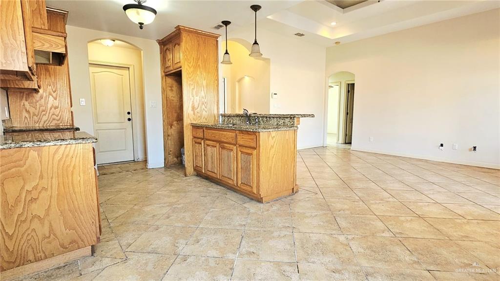 1004 West F Street Mission, TX 78572 - Photo 3 of 12 a large bathroom with a granite countertop sink a mirror and a shower
