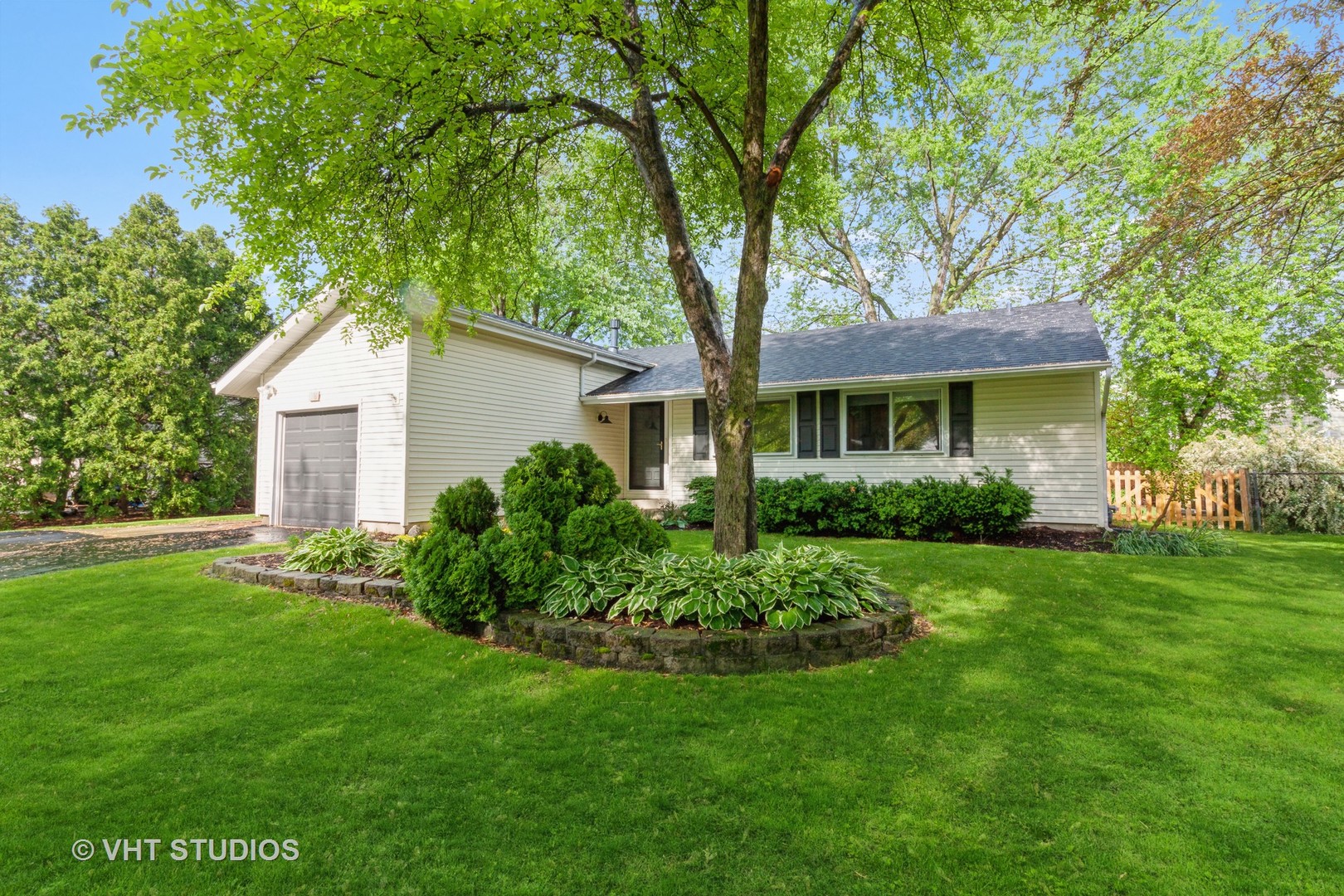 105 Cedarbrook Road Naperville, IL 60565 - Photo 1 of 11 a front view of a house with a garden