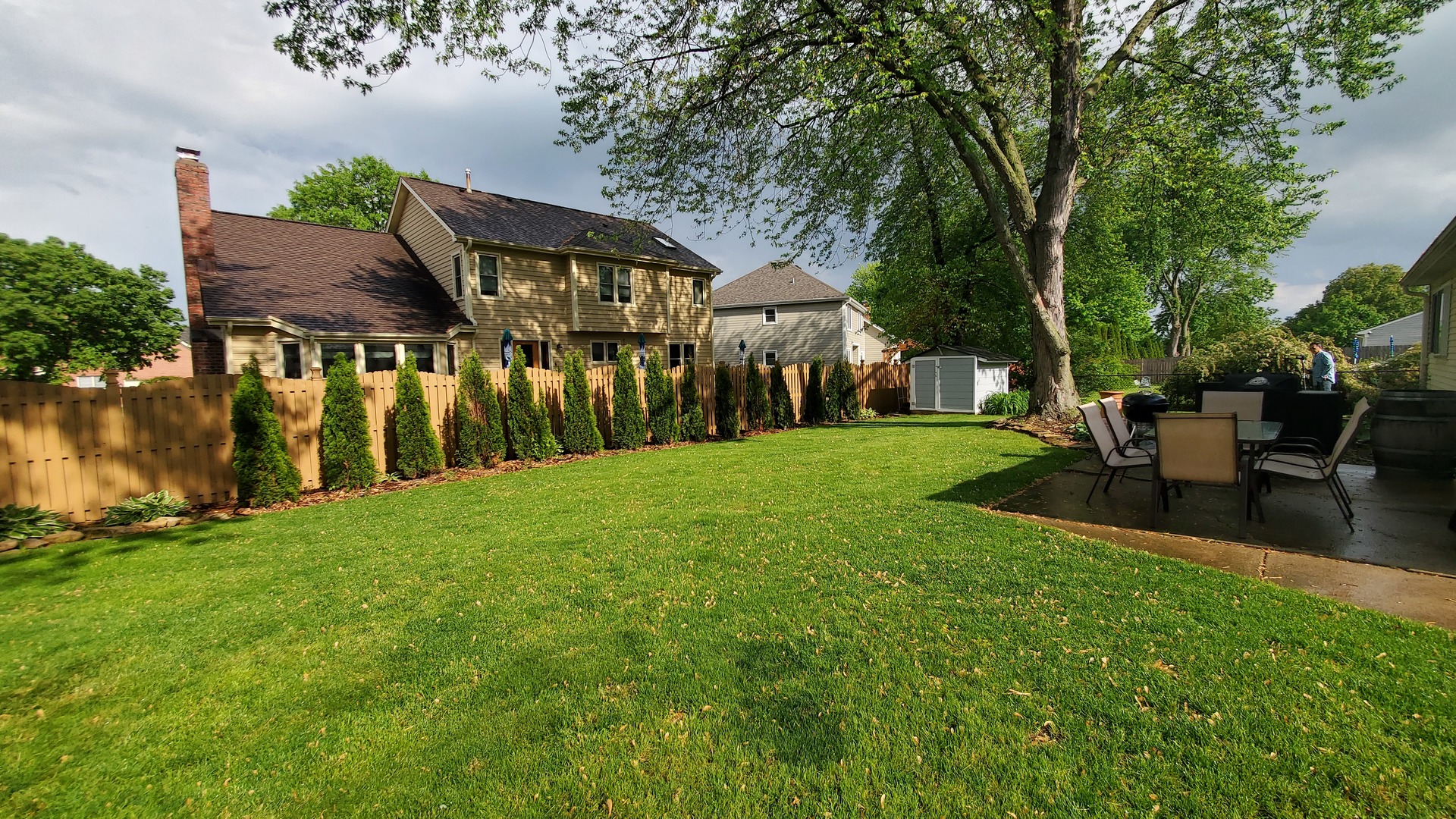 105 Cedarbrook Road Naperville, IL 60565 - Photo 11 of 11 a backyard of a house with table and chairs