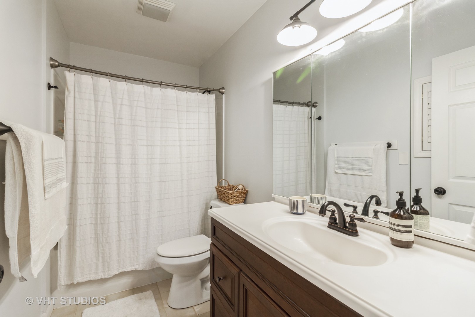 105 Cedarbrook Road Naperville, IL 60565 - Photo 8 of 11 a bathroom with a double vanity sink toilet and a mirror