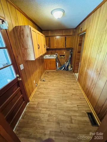 a view of kitchen with wooden floor and chair