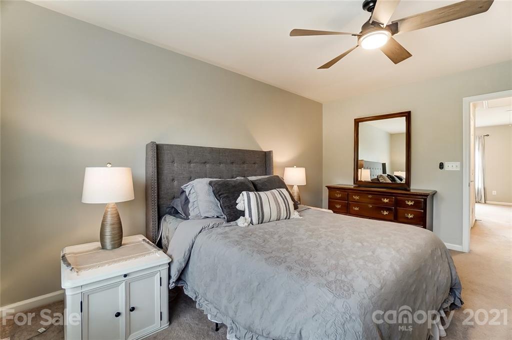 142 Council House Road Fort Mill, SC 29708 - Photo 22 of 32 a bedroom with a bed and a lamp on table