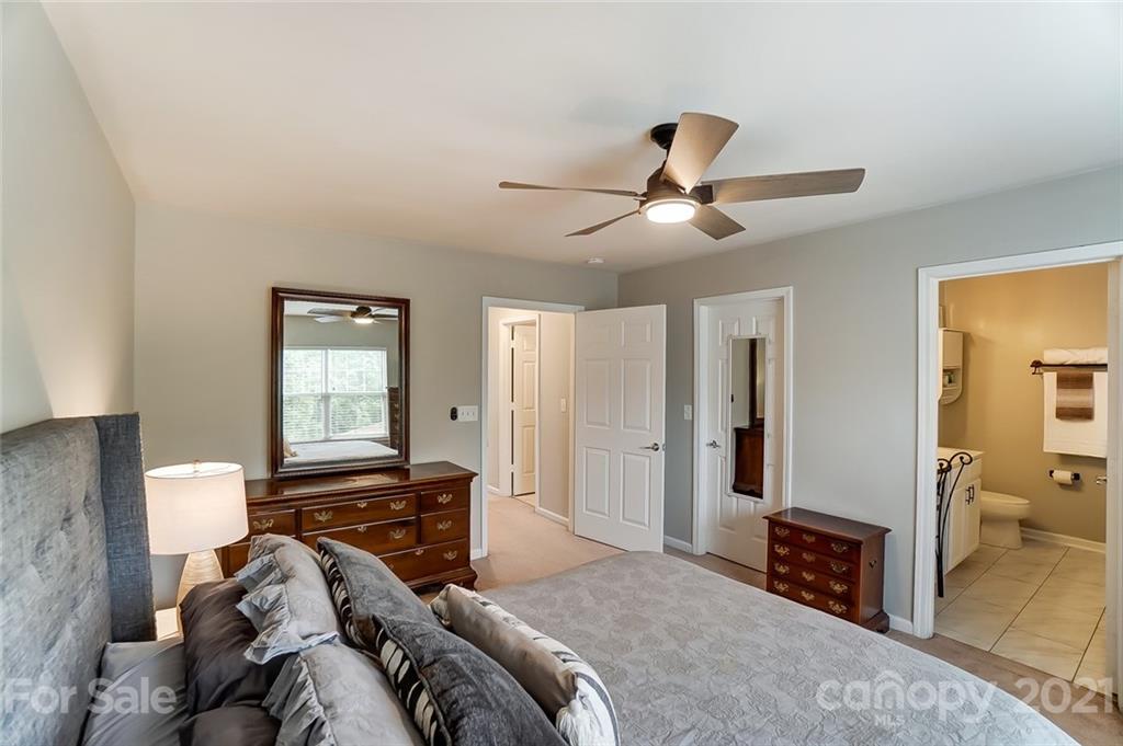 142 Council House Road Fort Mill, SC 29708 - Photo 23 of 32 a bedroom with a bed and a chandelier