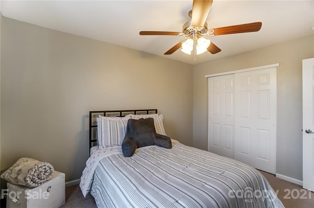 142 Council House Road Fort Mill, SC 29708 - Photo 26 of 32 a bedroom with a bed and a chandelier