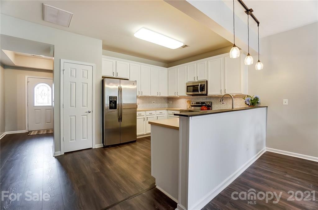 142 Council House Road Fort Mill, SC 29708 - Photo 6 of 32 a kitchen with granite countertop a refrigerator and a stove top oven