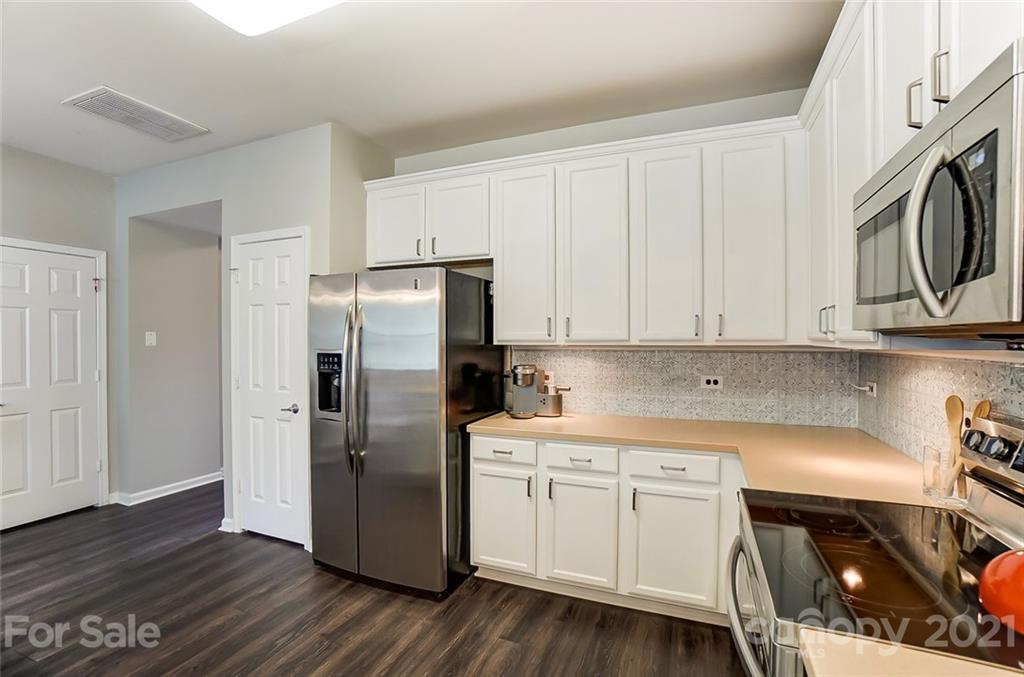142 Council House Road Fort Mill, SC 29708 - Photo 8 of 32 a kitchen with stainless steel appliances a refrigerator sink and cabinets
