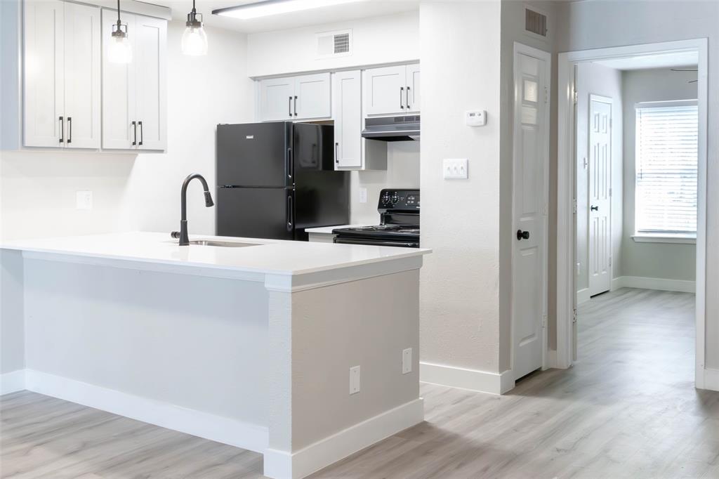 13266 Emily Road, Unit 124 Dallas, TX 75240 - Photo 7 of 8 a kitchen with stainless steel appliances a refrigerator sink and cabinets