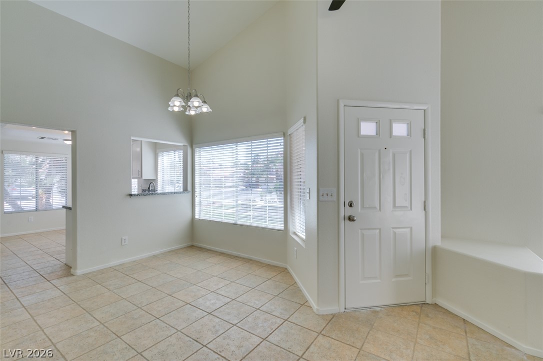 307 Cavalla Street Henderson, NV 89074 - Photo 44 of 44 An open floorplan dining area flows into the kitchen with vaulted ceilings and natural light.