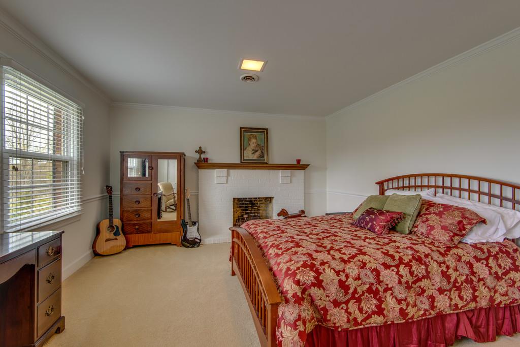 891 Sneed Road West Franklin, TN 37069 - Photo 17 of 30 a bedroom with a bed and a tv