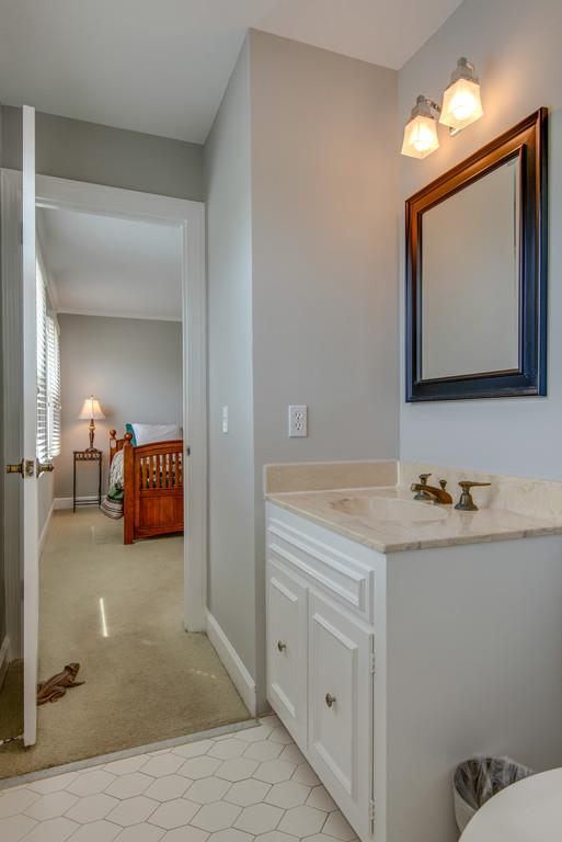 891 Sneed Road West Franklin, TN 37069 - Photo 18 of 30 a en suite bathroom with sink and mirror