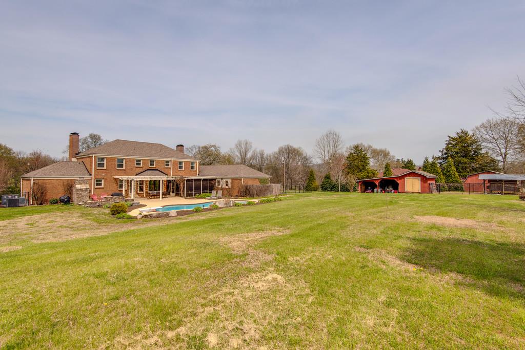891 Sneed Road West Franklin, TN 37069 - Photo 29 of 30 a front view of a house with a big yard and large trees