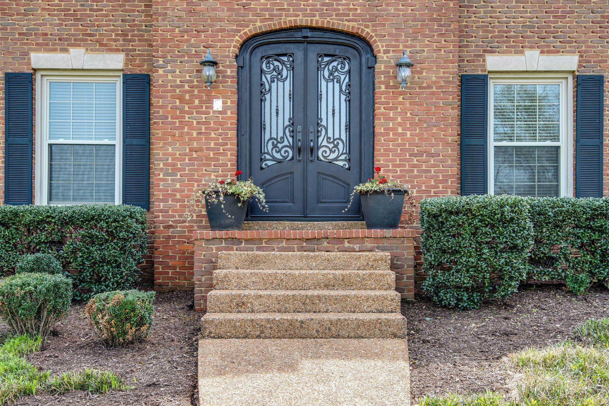 891 Sneed Road West Franklin, TN 37069 - Photo 3 of 30 a front view of a house with potted plants