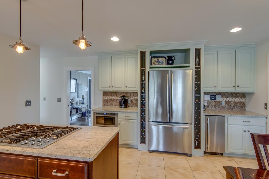 891 Sneed Road West Franklin, TN 37069 - Photo 10 of 30 a kitchen with stainless steel appliances granite countertop a refrigerator a stove and a sink