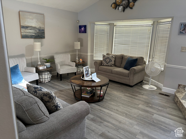 1874 South Main Street Orem, UT 84058 - Photo 6 of 15 Living area with vaulted ceiling and wood finished floors