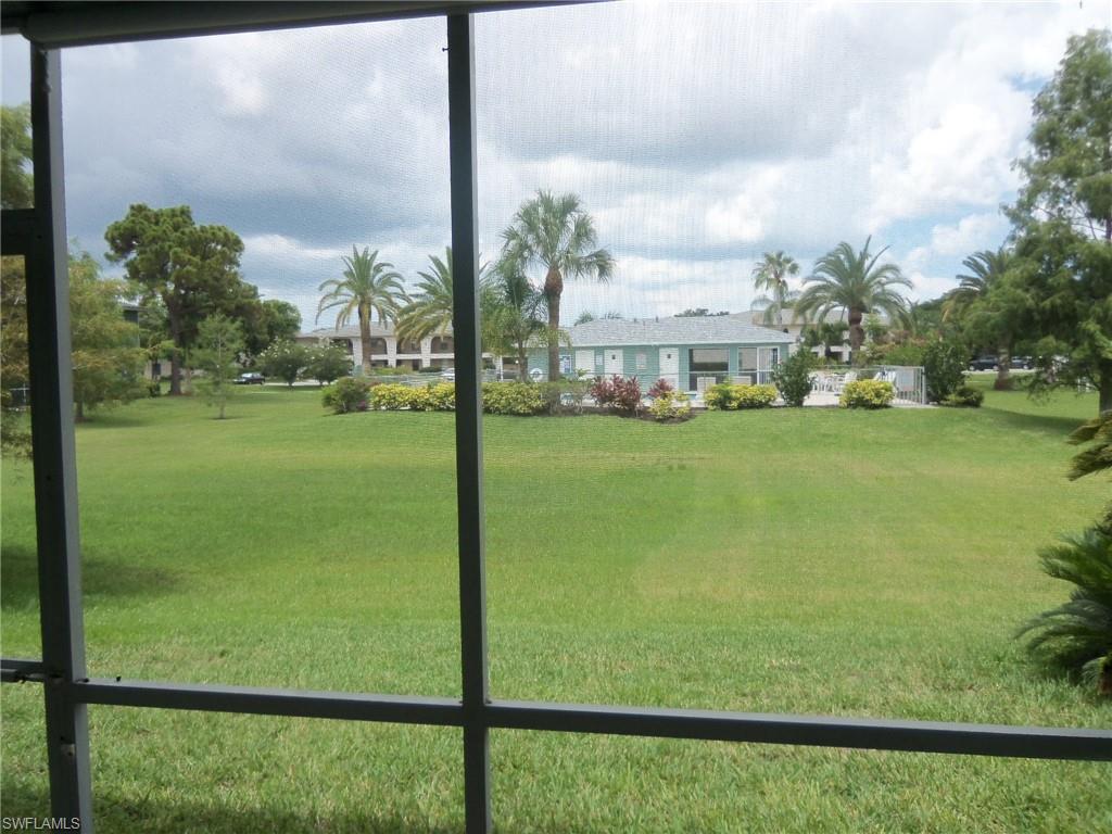144 Cypress Way East, Unit 702 Naples, FL 34110 - Photo 11 of 18 a view of a garden from a windows