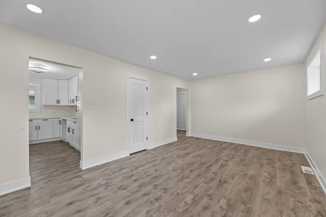 a view of room with window and wooden floor