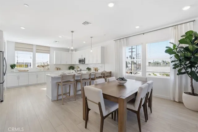 a kitchen with a dining table chairs and stove
