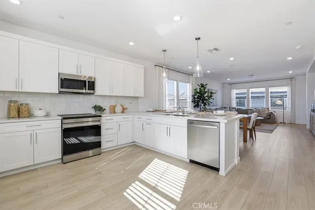 a kitchen with a white stove top oven and cabinets
