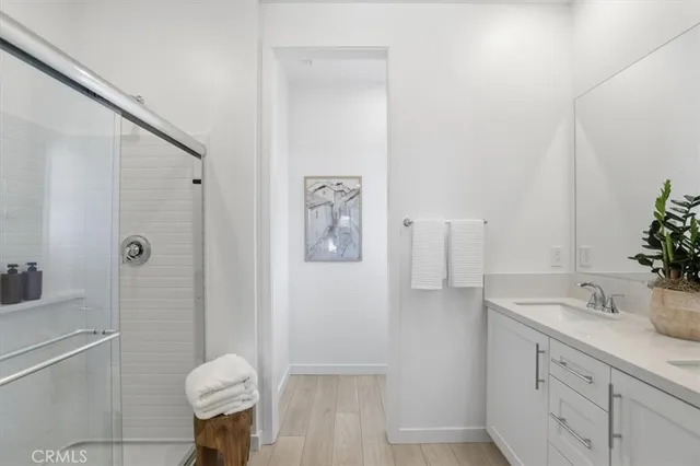 a bathroom with a shower sink and mirror