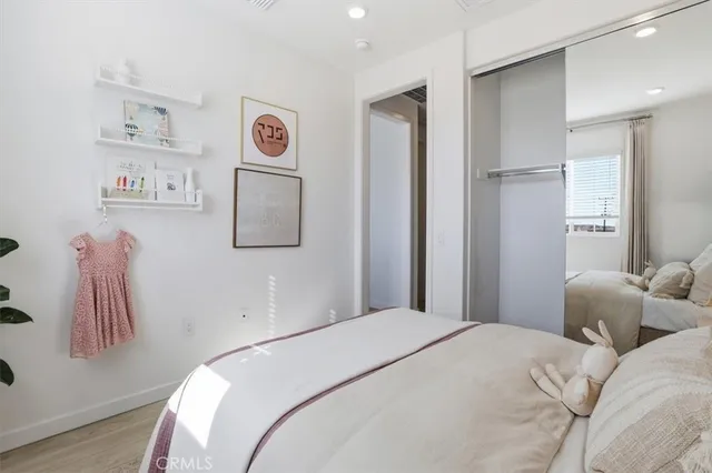 a bedroom with a bed and a painting on the wall