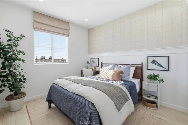 a bedroom with a bed and a potted plant