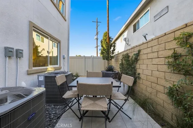 a view of a patio with table and chairs and potted plants
