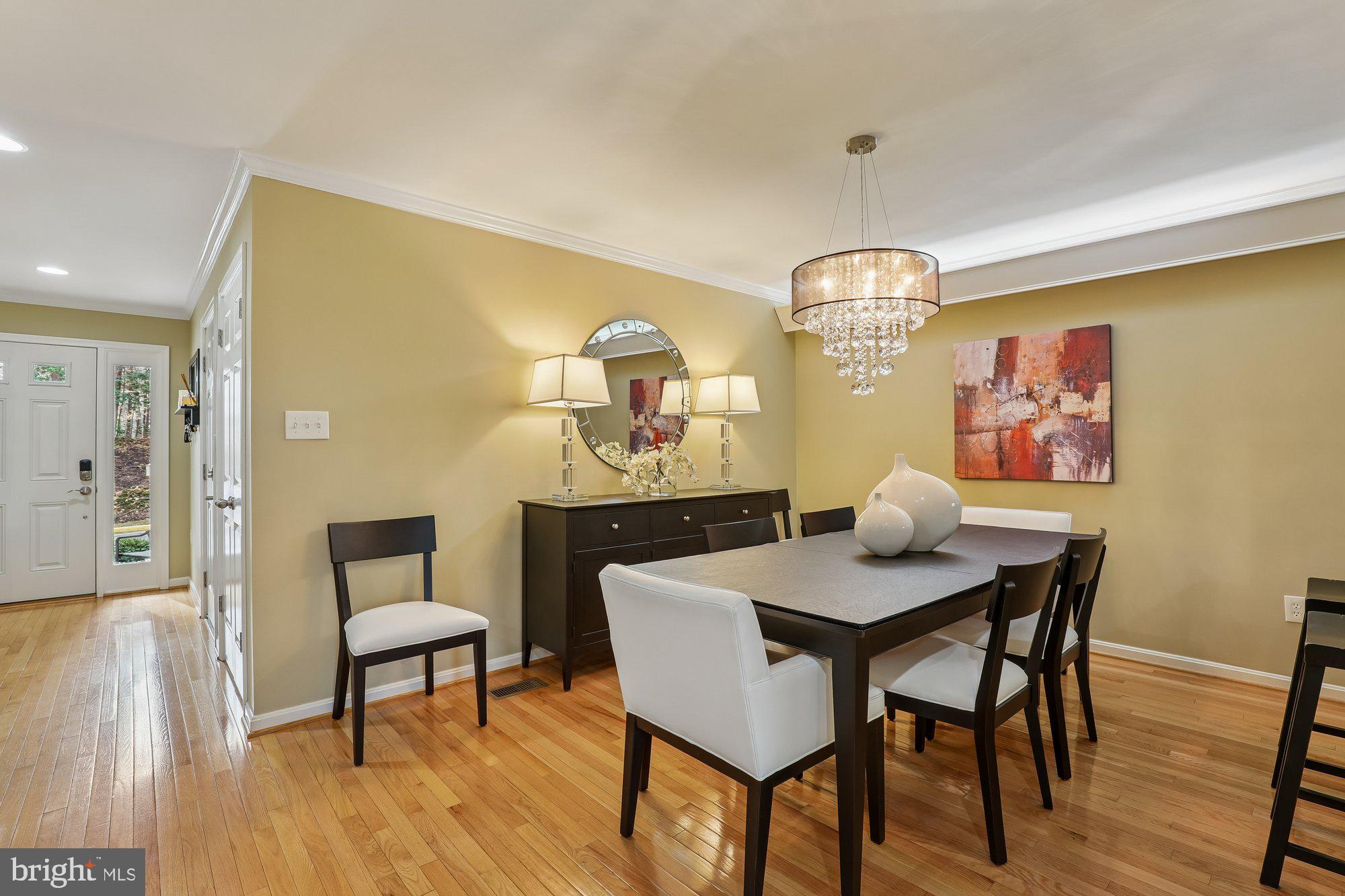 8019 Galla Knoll Circle Springfield, VA 22153 - Photo 10 of 57 a view of a dining room with furniture and wooden floor
