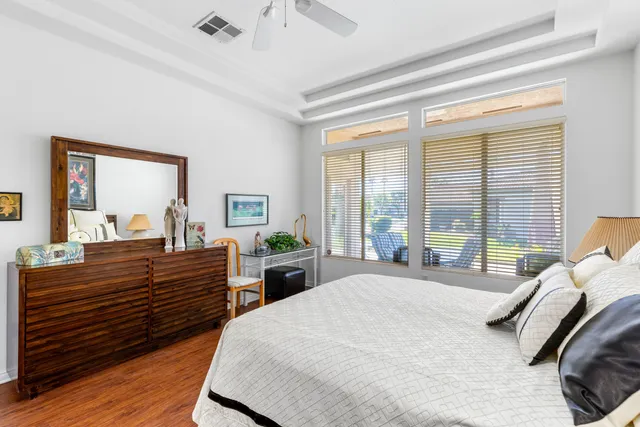 a bedroom with furniture and a large mirror