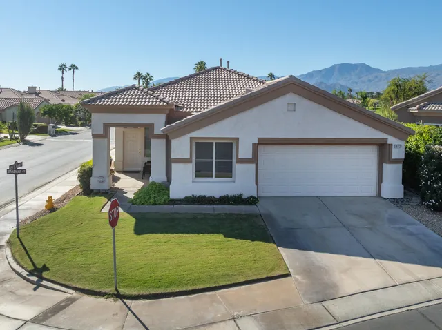 a view of a bedroom with furniture and windows