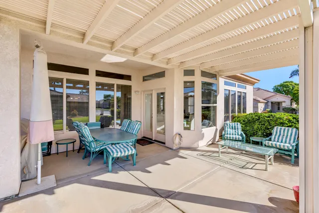 a view of a house with backyard porch and sitting area