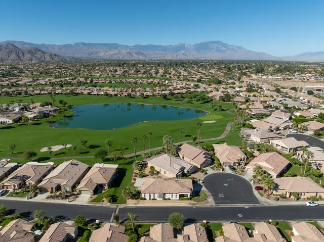 an aerial view of a house with swimming pool garden and patio