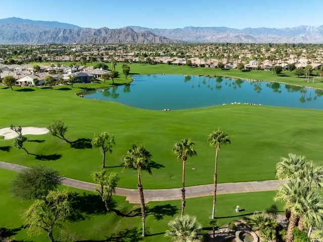 a view of a swimming pool with a yard and outdoor seating