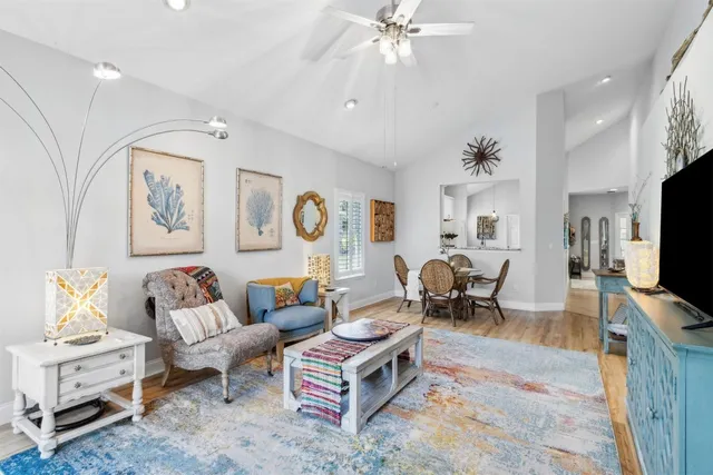a bedroom with a bed window and walk in closet with wooden floor