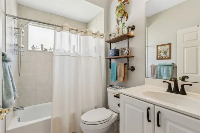 a view of a balcony with wooden floor and furniture