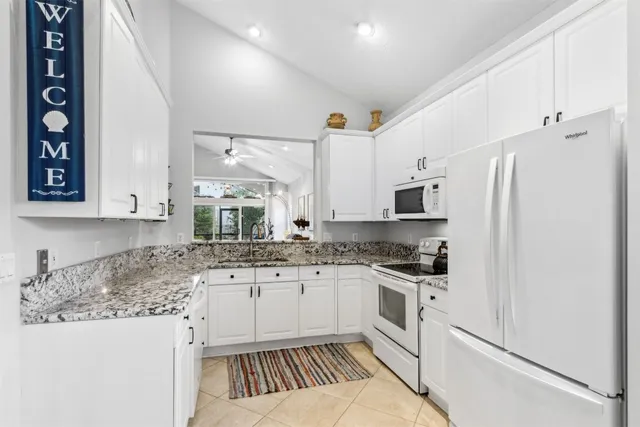 a dining room with furniture a rug and a large window