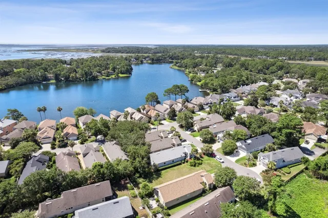 a view of a swimming pool with a lawn chairs and a fire pit