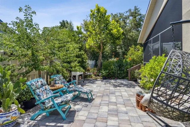 an aerial view of ocean and residential houses with outdoor space