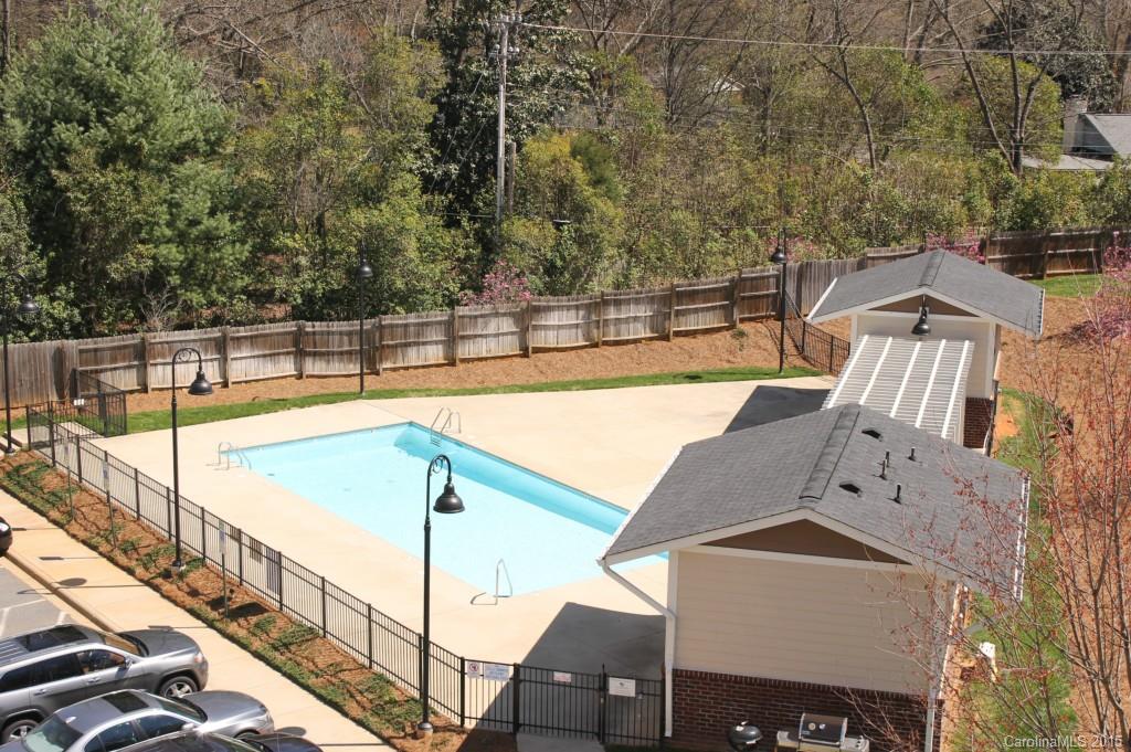 1000 East Woodlawn Road, Unit 405 Charlotte, NC 28209 - Photo 2 of 15 a view of a balcony with two chairs