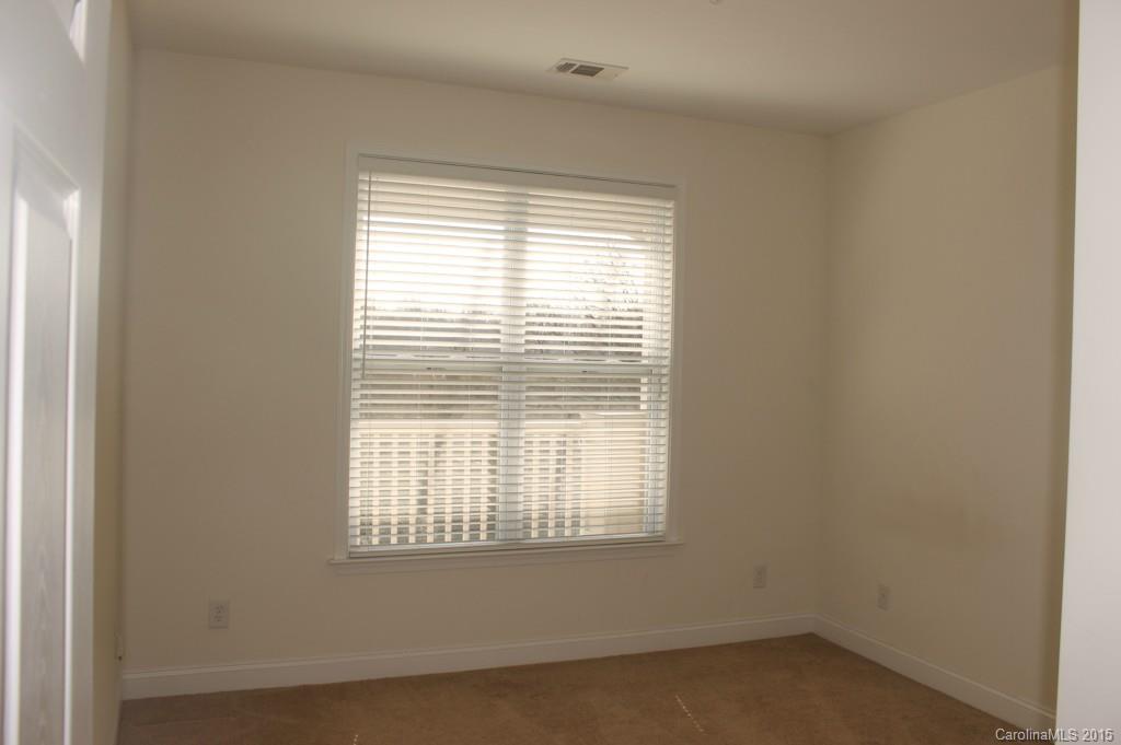 1000 East Woodlawn Road, Unit 405 Charlotte, NC 28209 - Photo 12 of 15 a view of an empty room with a window