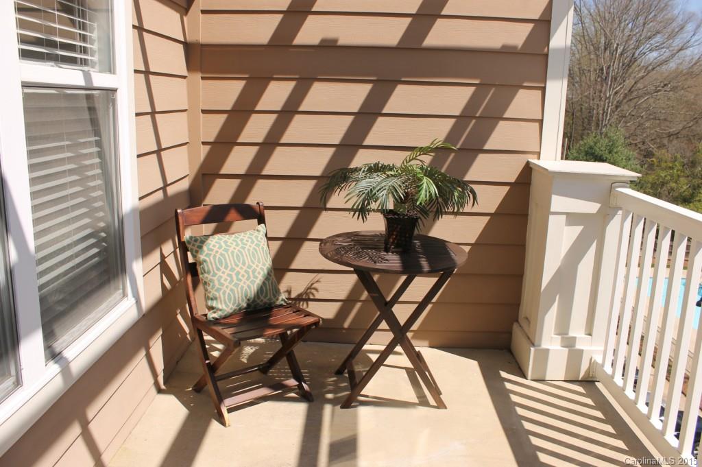 1000 East Woodlawn Road, Unit 405 Charlotte, NC 28209 - Photo 3 of 15 a view of a chairs and table in the balcony