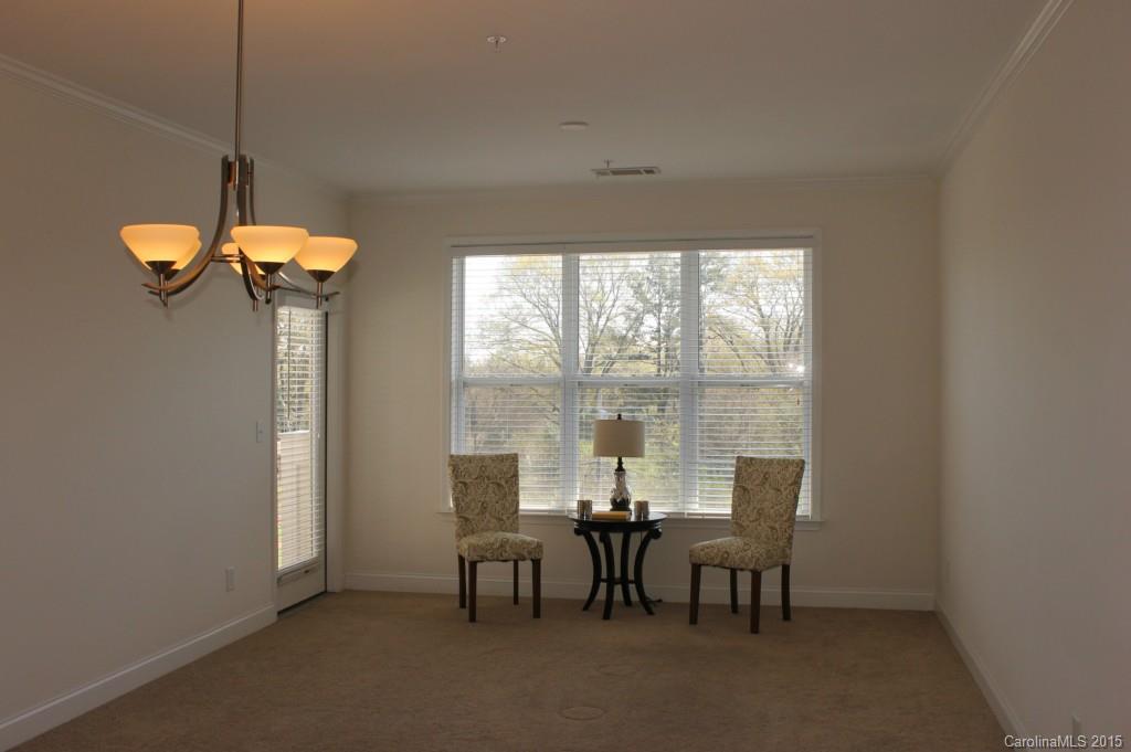 1000 East Woodlawn Road, Unit 405 Charlotte, NC 28209 - Photo 5 of 15 a view of a dining room with furniture window and outside view