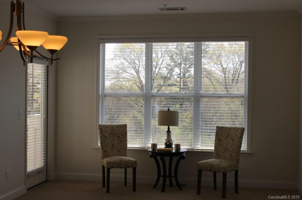 1000 East Woodlawn Road, Unit 405 Charlotte, NC 28209 - Photo 7 of 15 a view of a dining room with furniture window and outside view