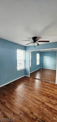 a view of room with window and wooden floor