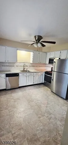 a kitchen with stainless steel appliances a sink dishwasher stove and cabinets