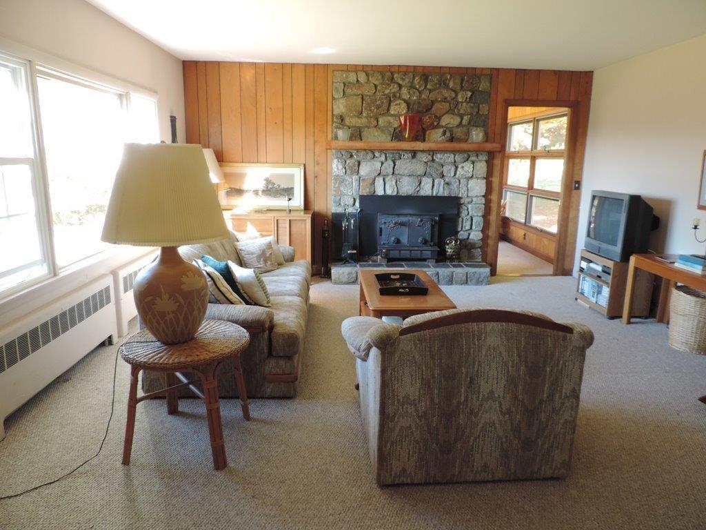 Another view of sunny living room. A...